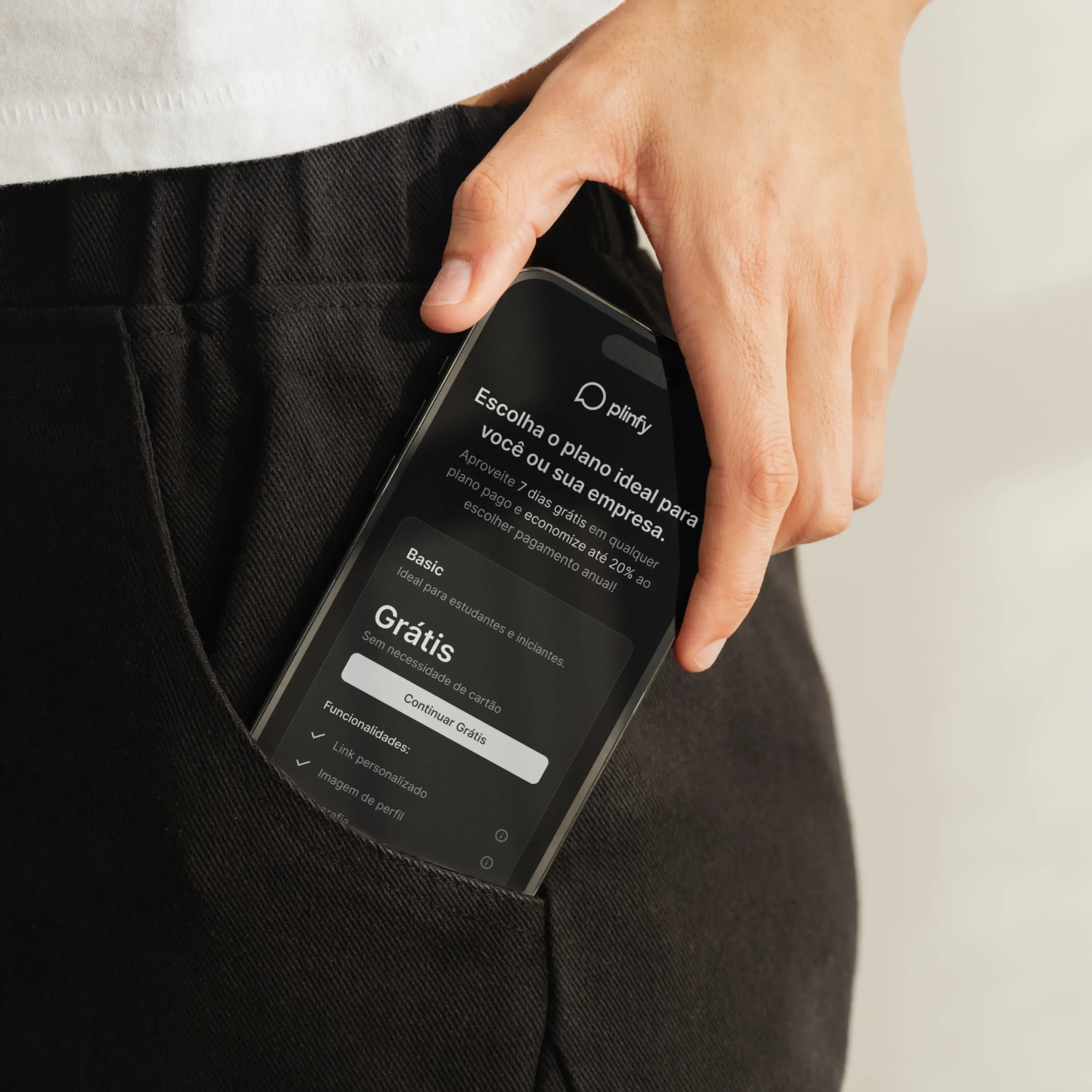 Imagem de um celular no bolso de uma pessoa com o site da Plinfy